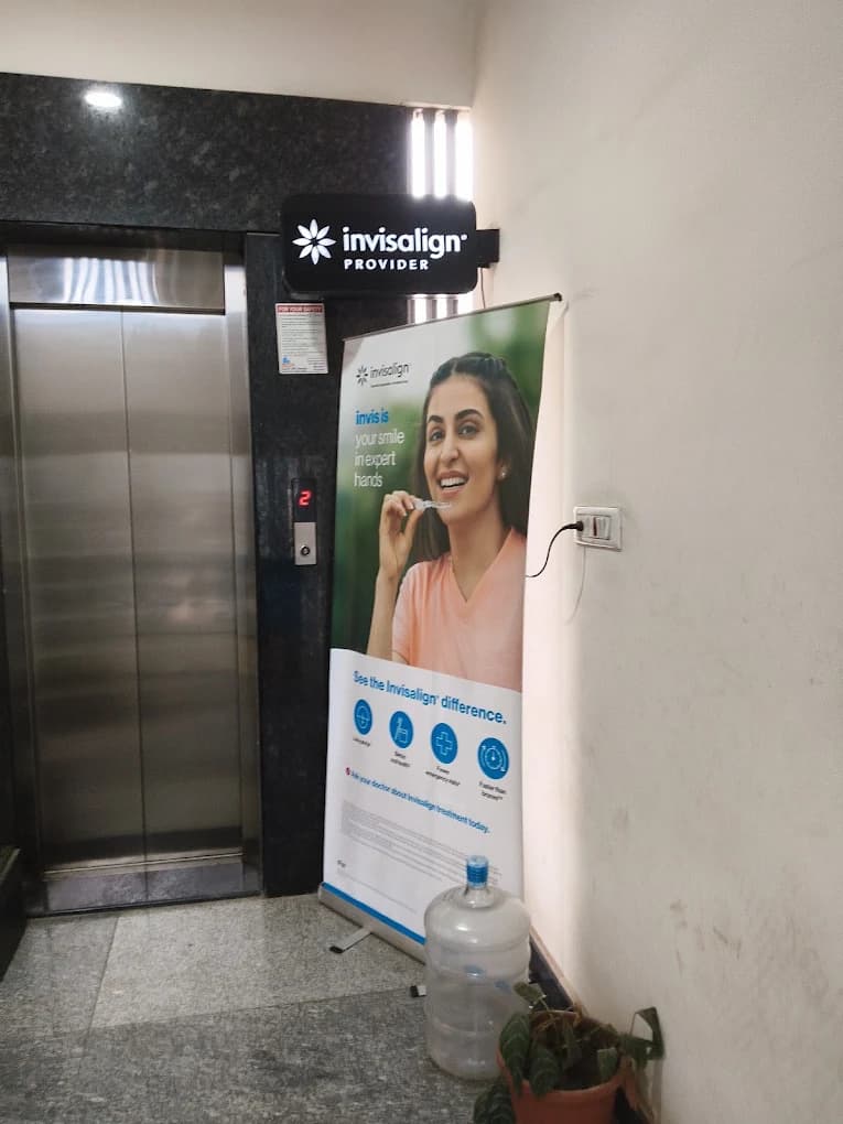 Second-floor clinic entrance and elevator lobby with Invisalign Provider sign